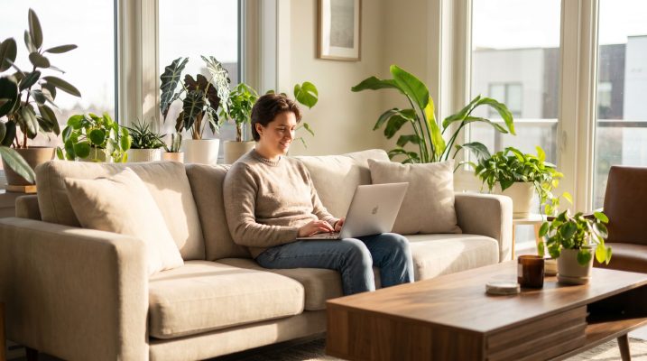 person on a sofa learning about online business on a laptop